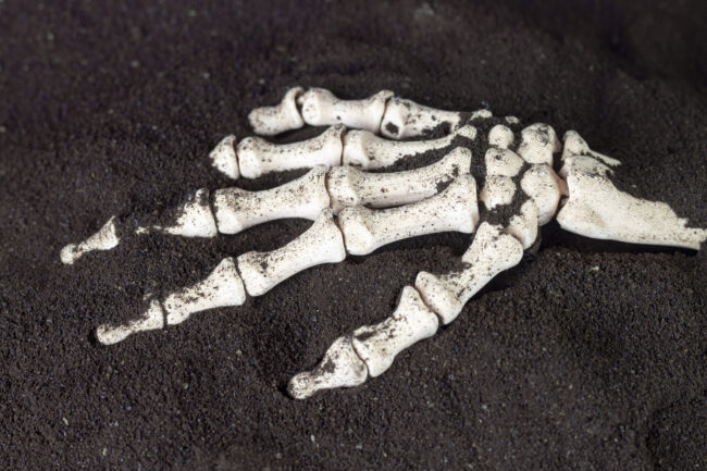 skeletal-hand-emerges-from-disturbed-earth