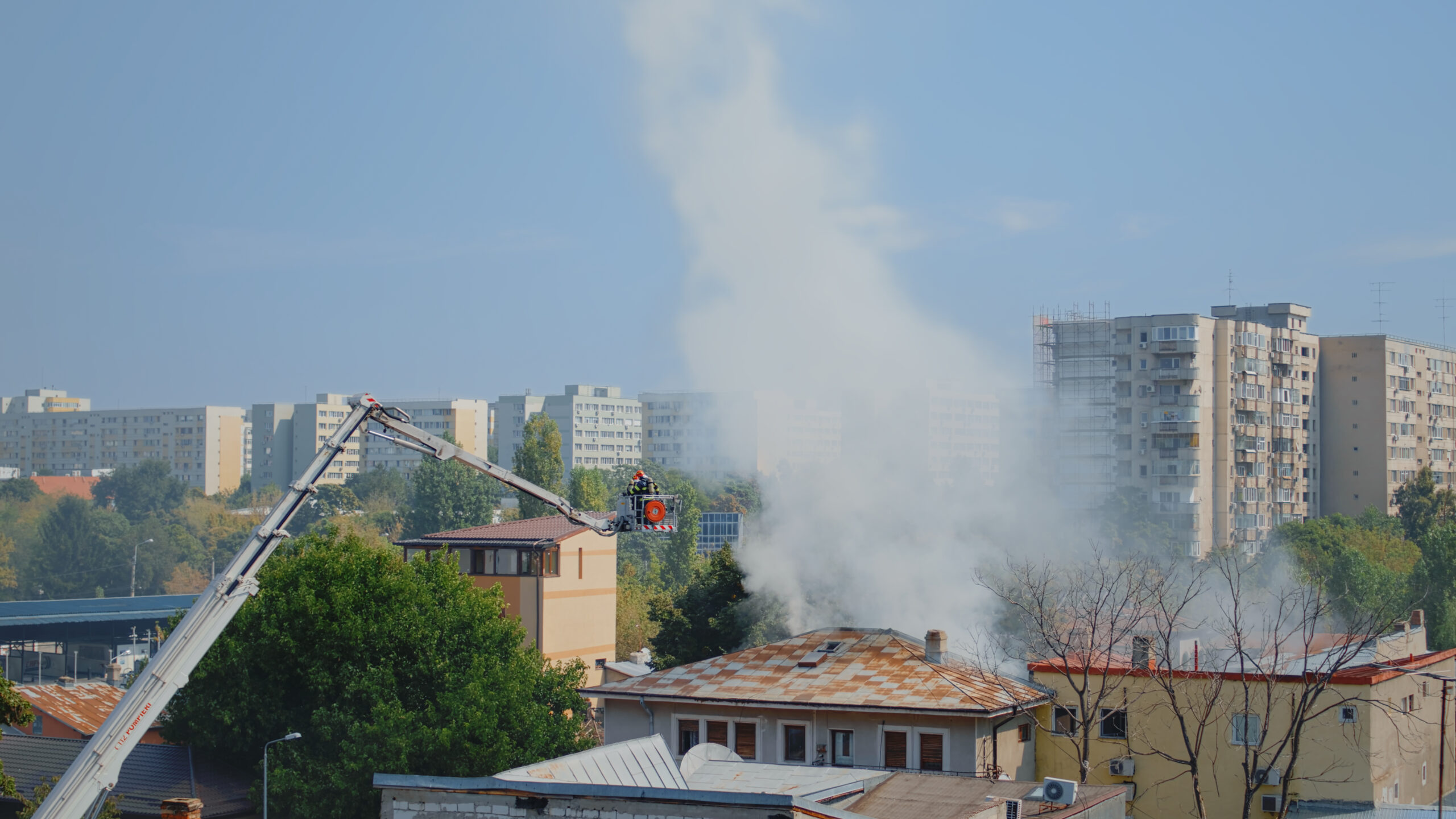House burning in city neighbourhood and firefighters helping
